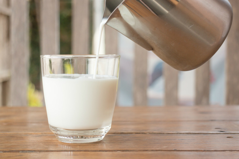 white milk being poured into a glass