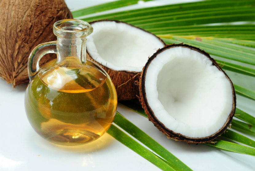 bottle of coconut oil beside a coconut