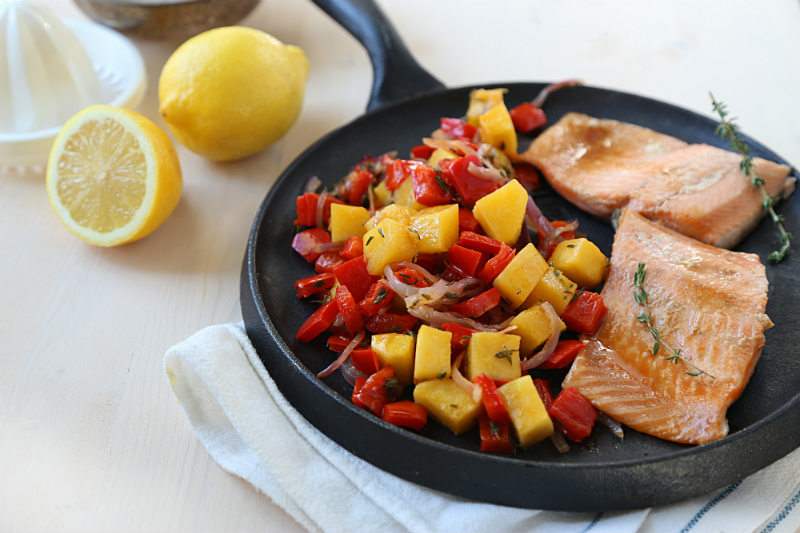 glazed trout and roasted vegetables on a skillet