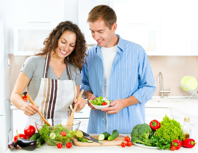 a couple in the kitchen making a healthy meal